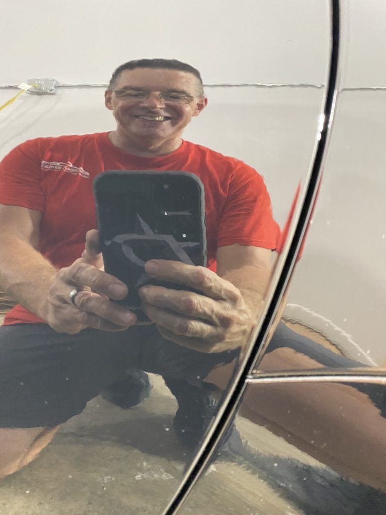 A man is taking a picture of himself in a mirror.