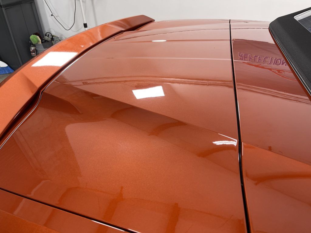 A close up of the roof of an orange car