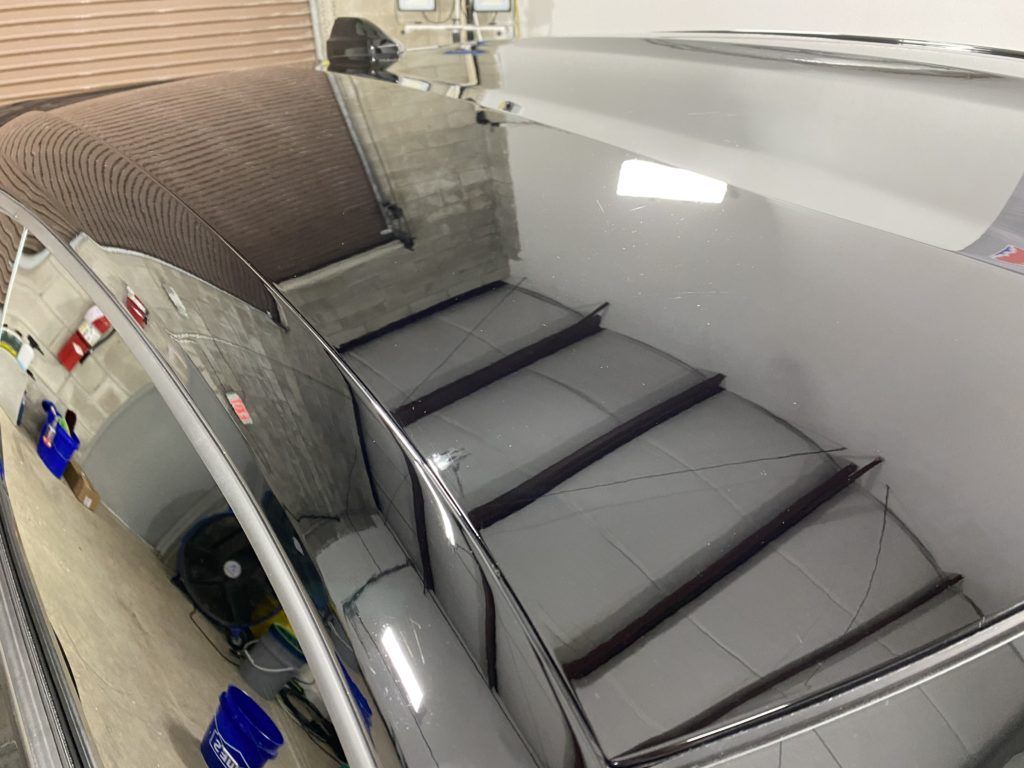 A car is sitting on top of a staircase in a garage.