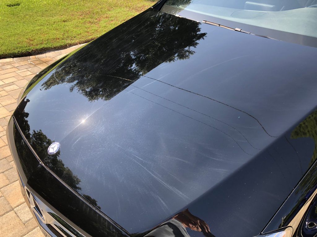 A close up of the hood of a black car.