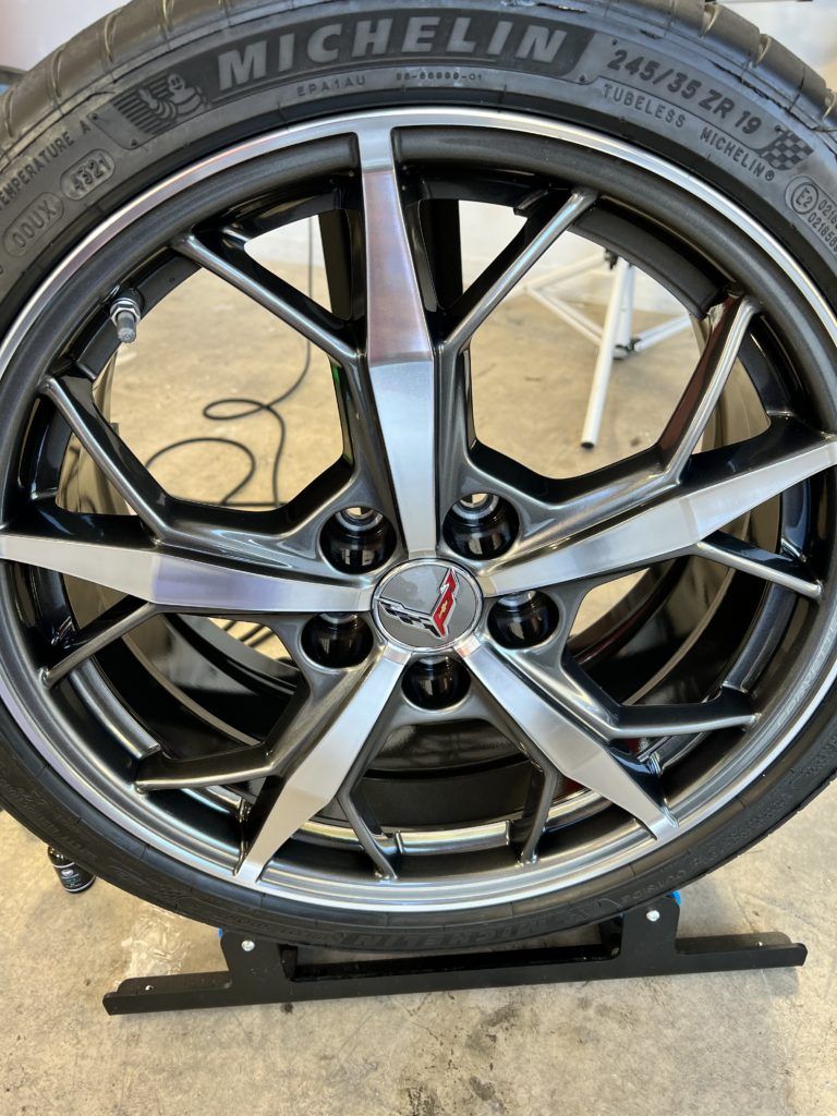 A close up of a michelin tire on a car wheel.