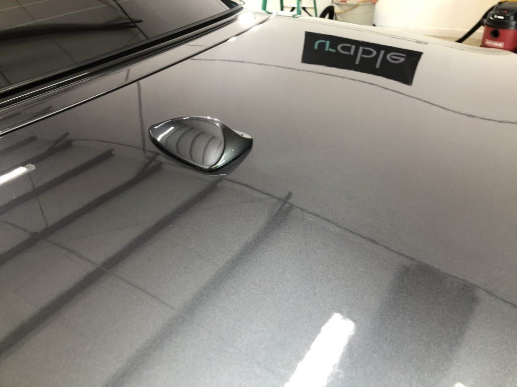 A close up of a car 's hood in a garage