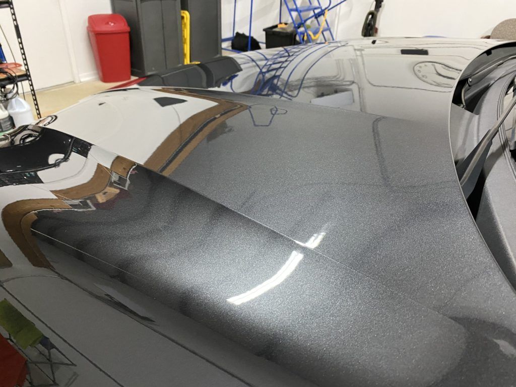 A close up of a car hood in a garage