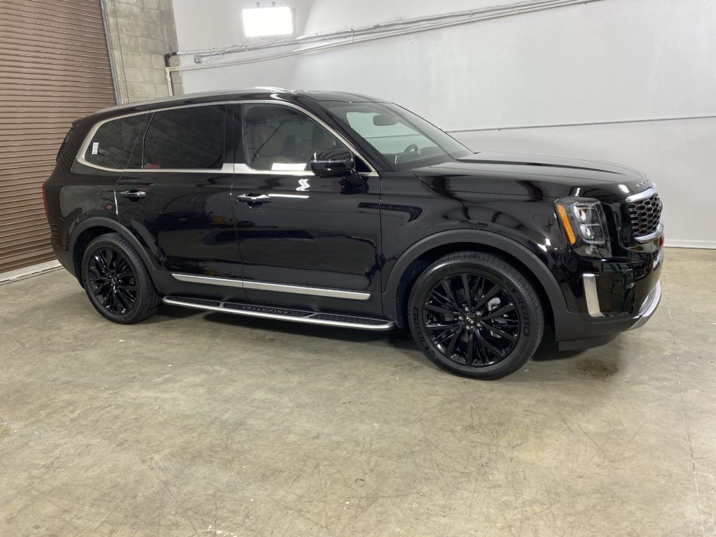 A black suv is parked in a garage.