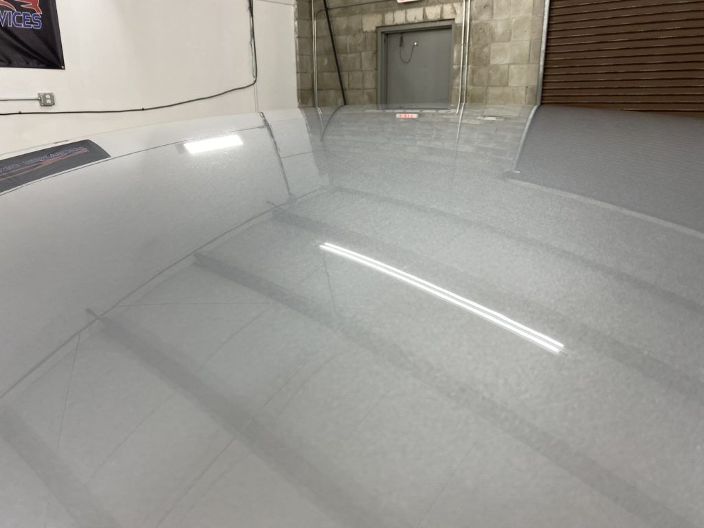 A close up of a shiny white floor in a garage.