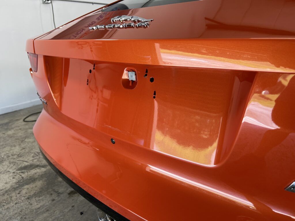 A close up of the back of an orange car