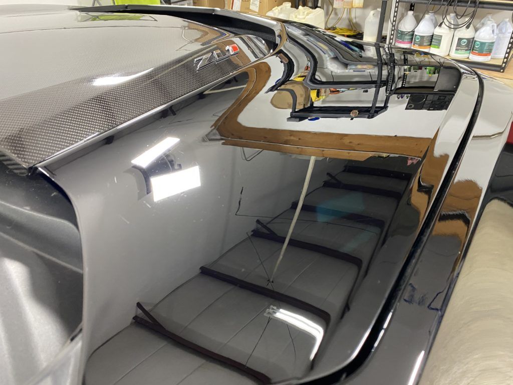 A close up of a car windshield in a garage.