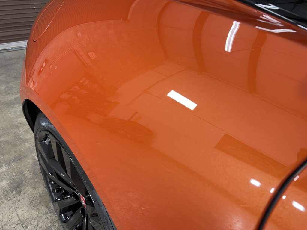 A close up of a car 's fender in a garage.
