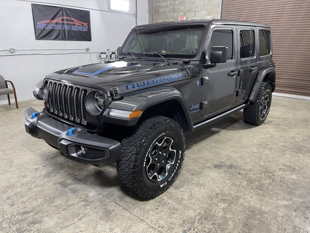 A jeep wrangler unlimited is parked in a garage.