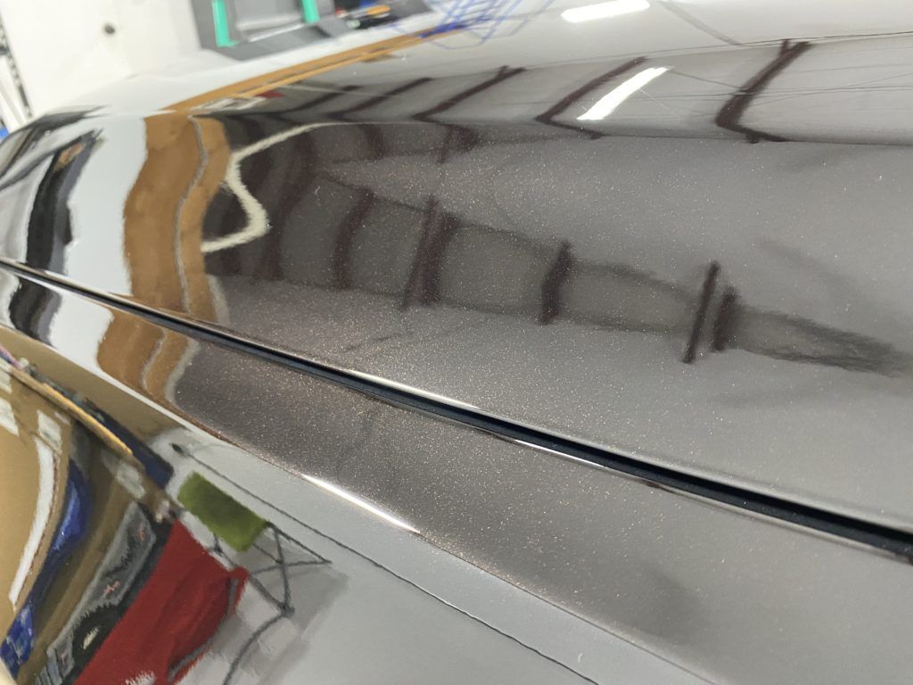 A close up of the hood of a car in a garage