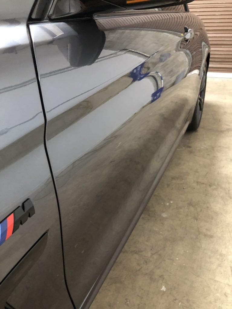 A close up of a car door with a bmw logo on it