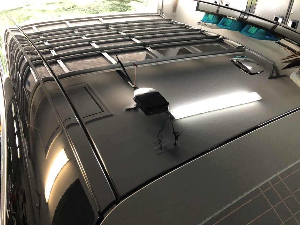 The roof of a car with a roof rack on it.