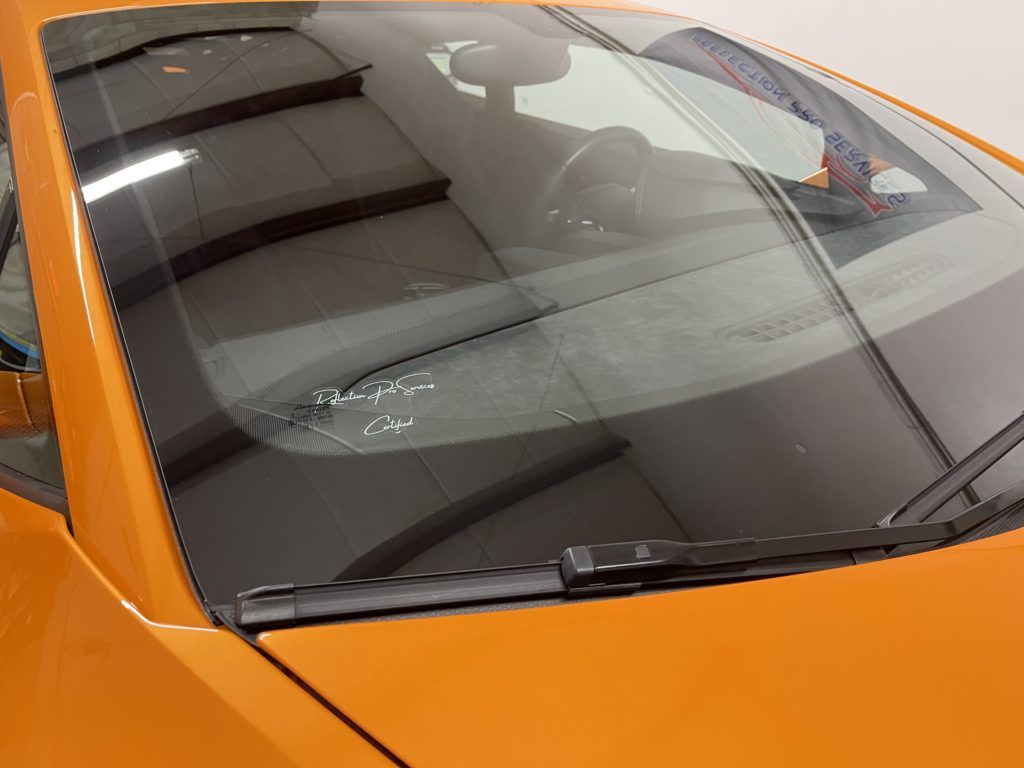 A close up of the windshield of an orange car