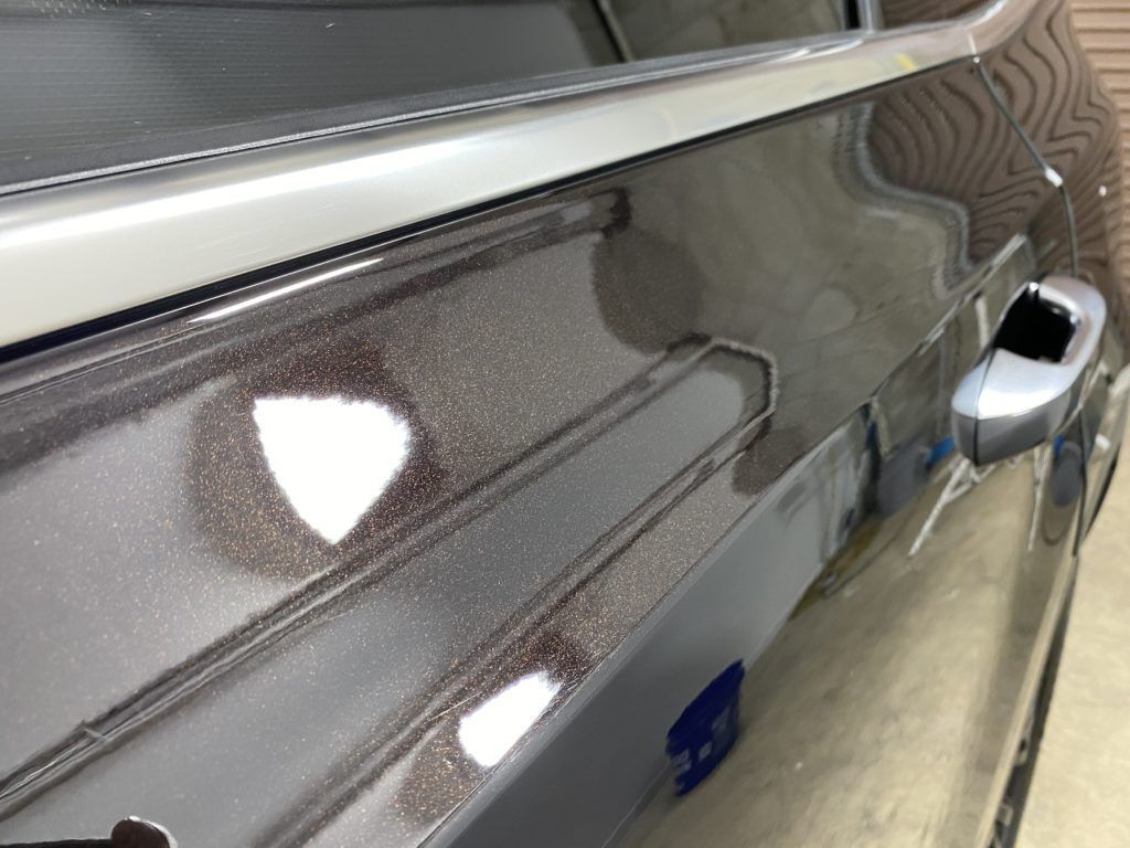 A close up of the side of a car with a window.