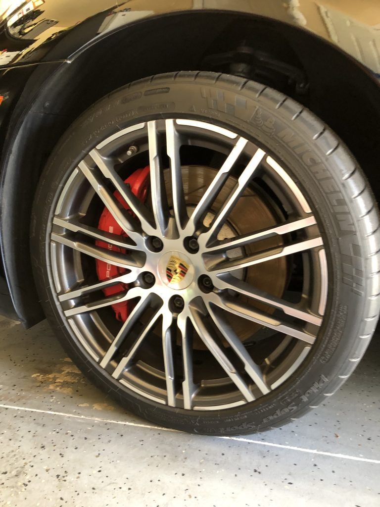 A close up of a car wheel with a tire on it
