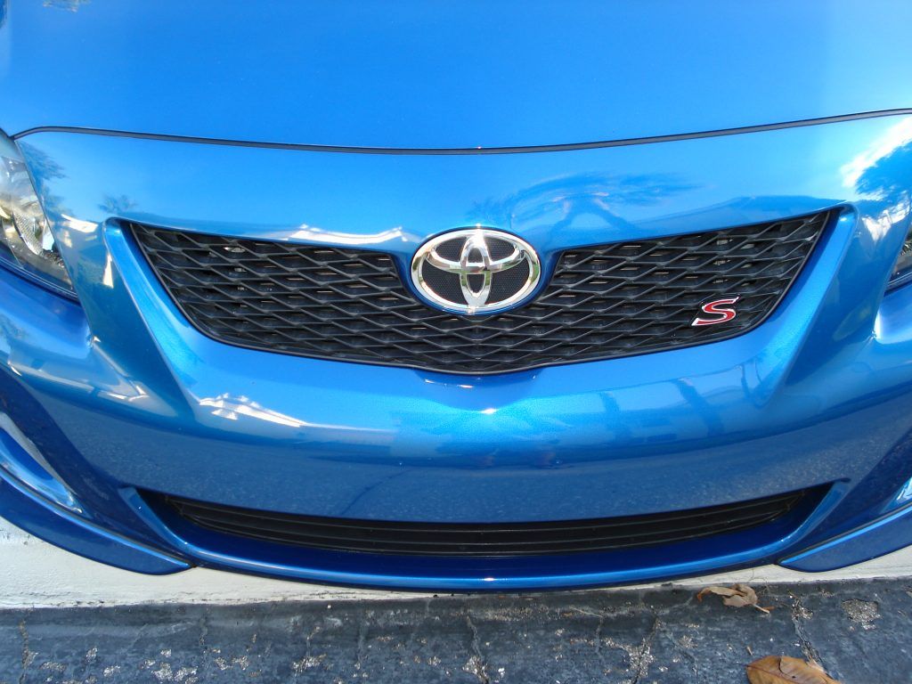 A blue toyota car is parked in a parking lot