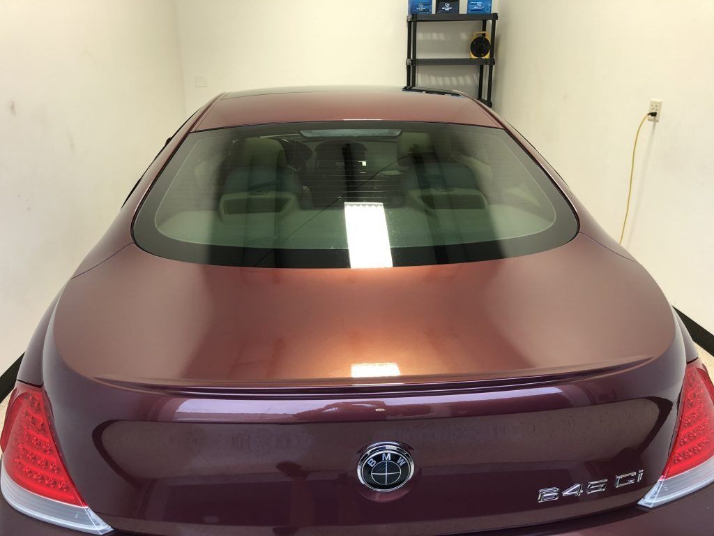A purple buick car is parked in a garage