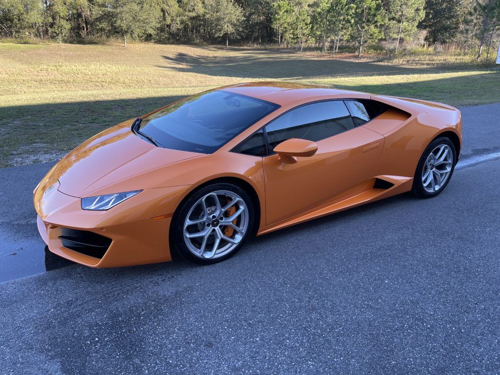 A lamborghini huracan is parked on the side of the road.
