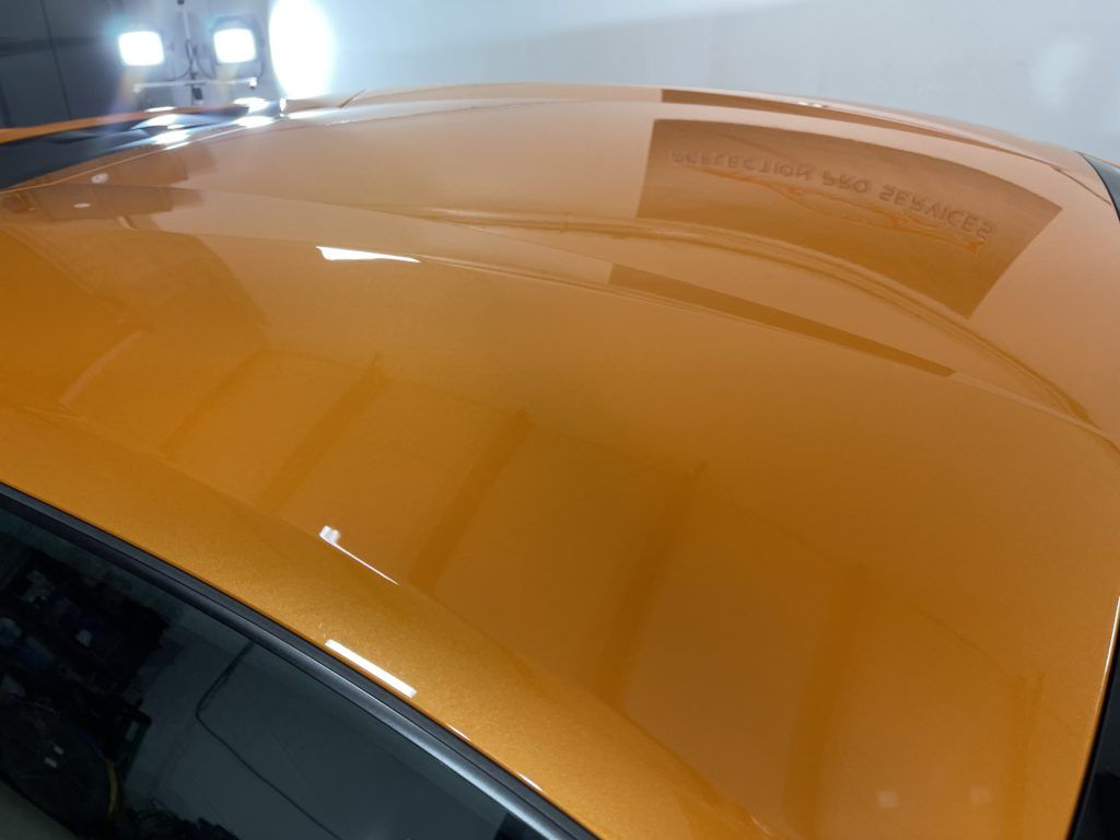 A close up of the roof of an orange car