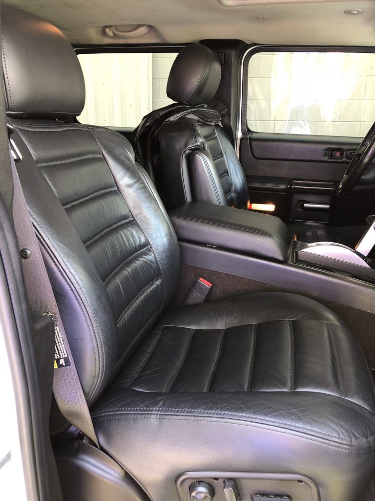 The front seats of a hummer h2 are black leather.
