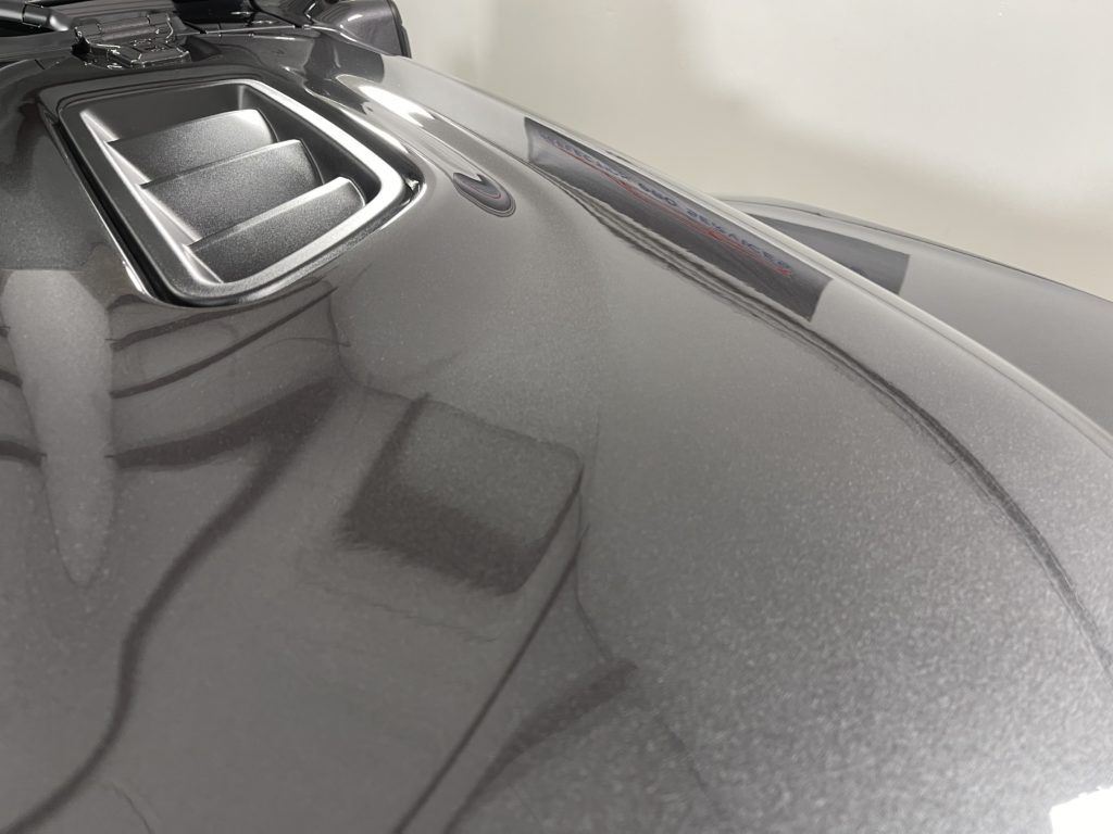 A close up of the hood of a black car