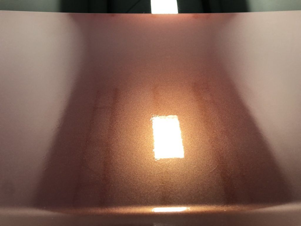 A close up of a light shining on a surface.
