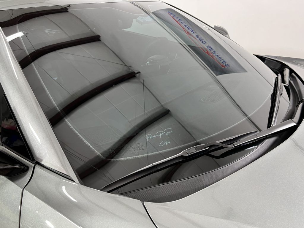 A close up of the windshield of a silver car