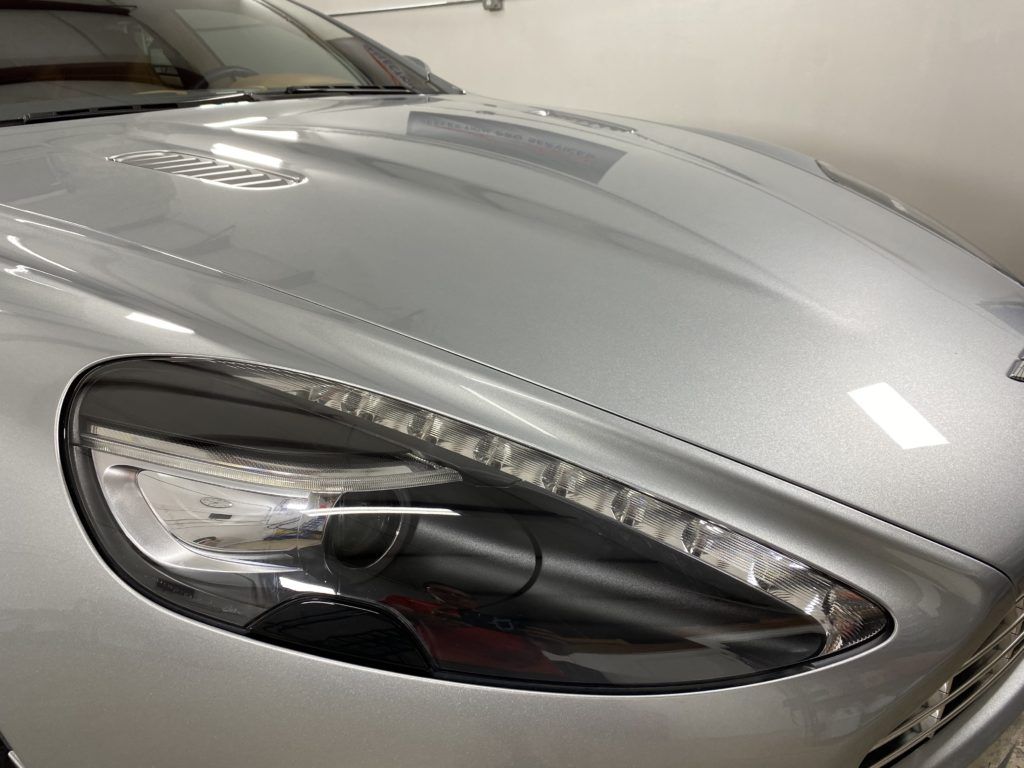 A close up of the hood of a silver car