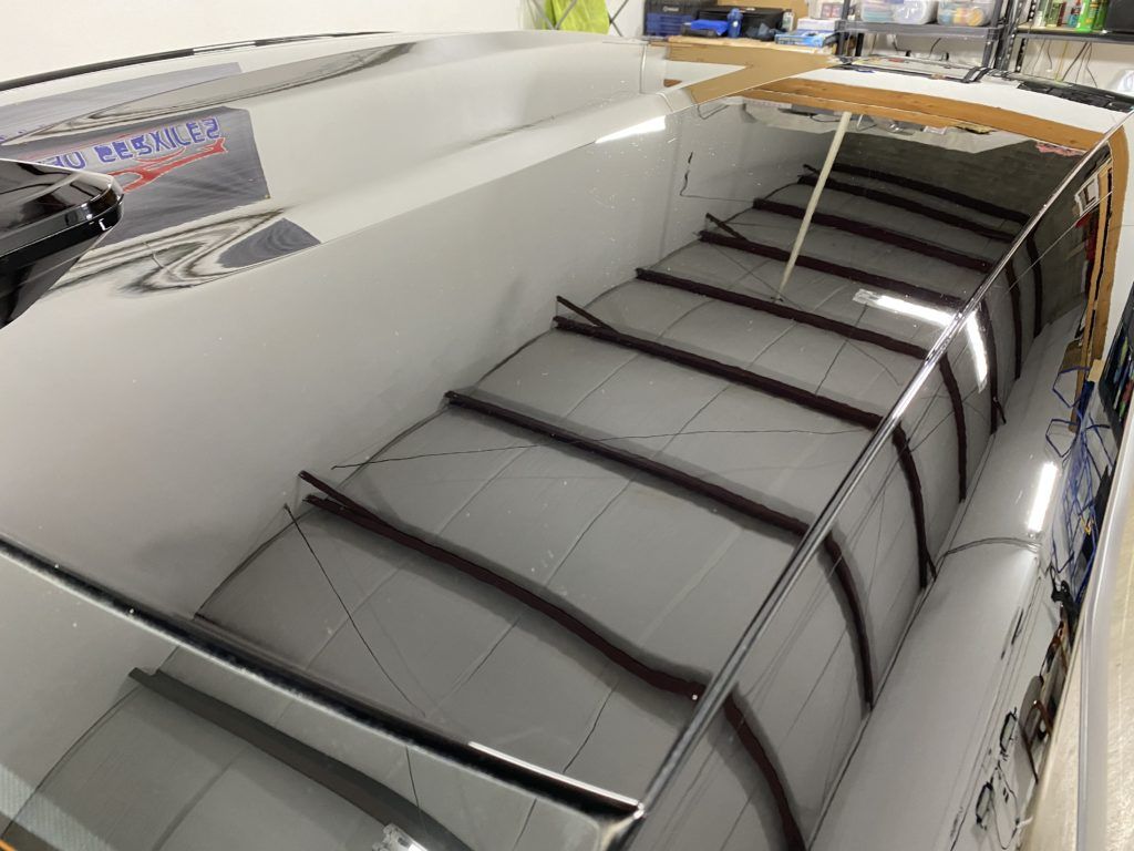 A close up of a boat being built in a room.