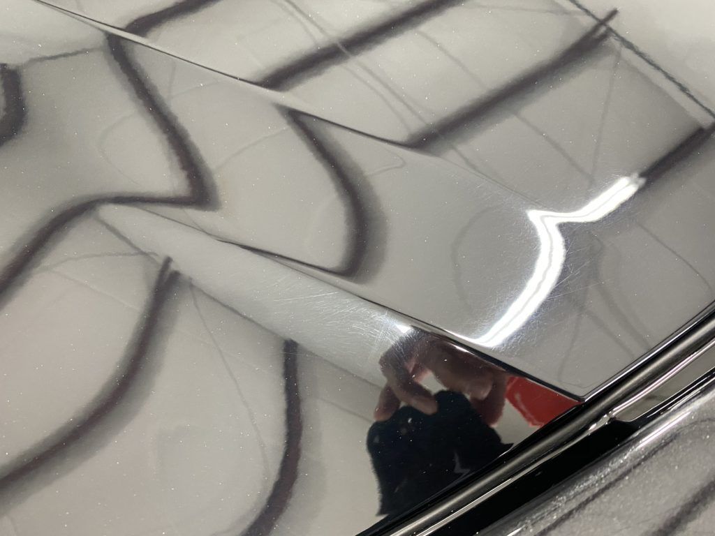 A person is taking a picture of their reflection in a mirror.