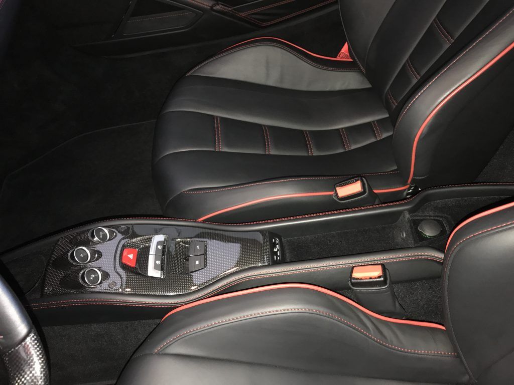 A black car with red stitching on the seats