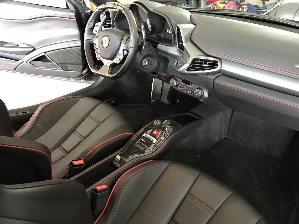 The interior of a ferrari sports car is shown.