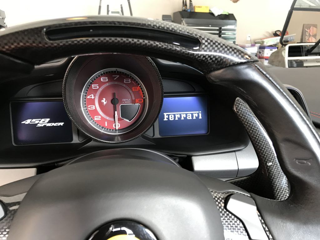 A close up of the dashboard of a ferrari car