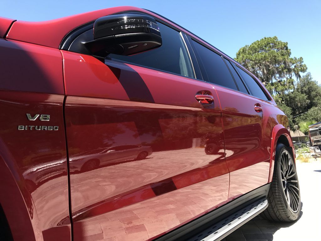A red car with the word v8 on the side