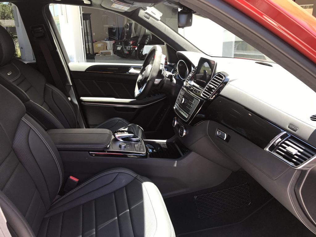 The interior of a red car with black and white seats