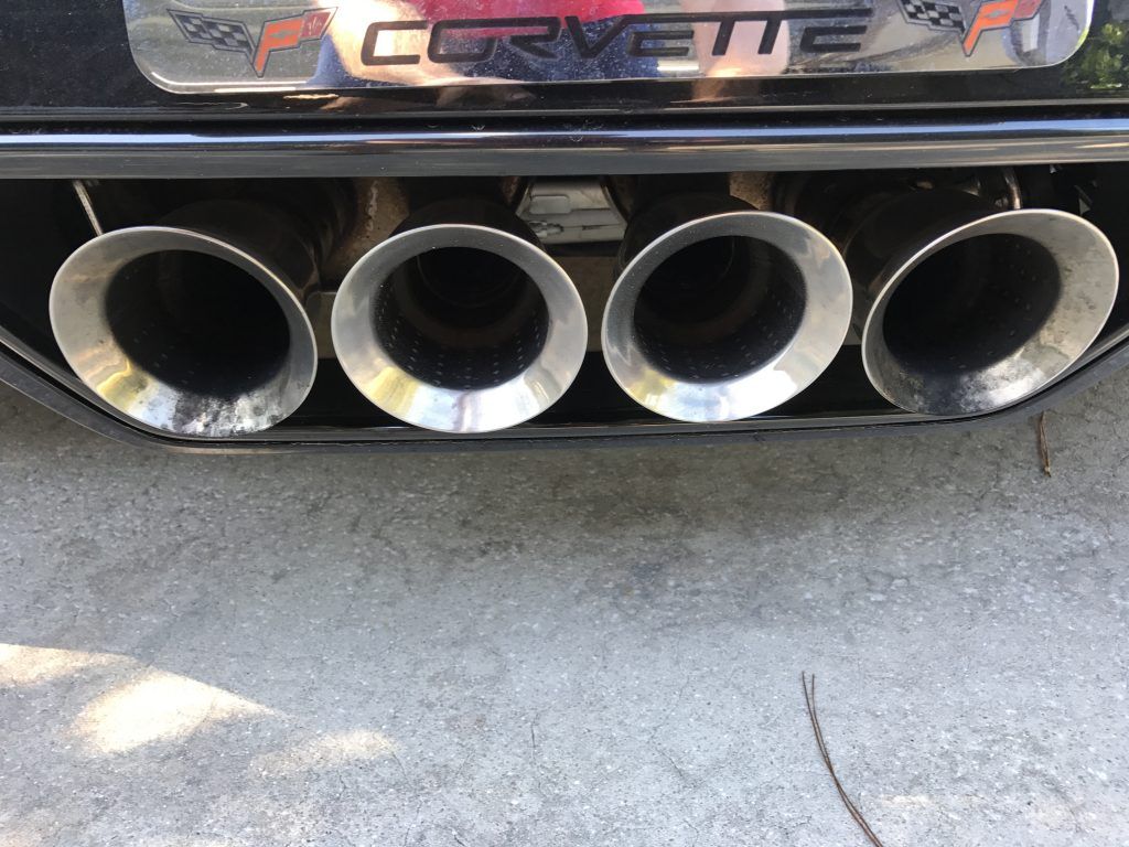 A close up of the exhaust pipes of a corvette