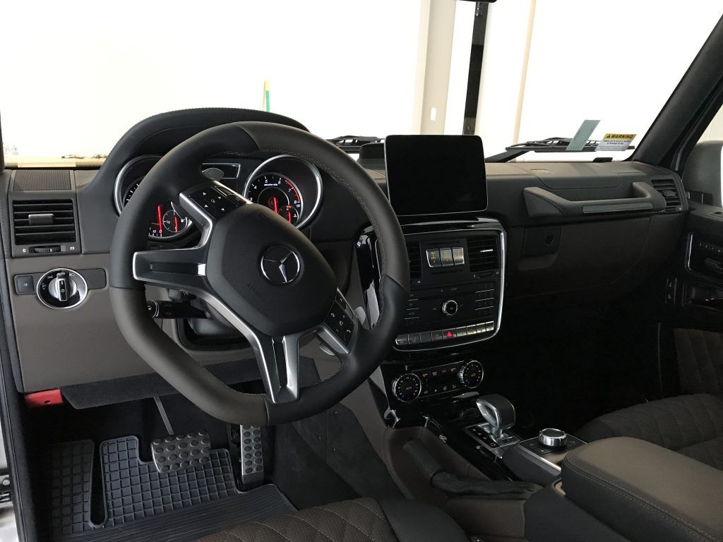 The interior of a car with a steering wheel and dashboard.