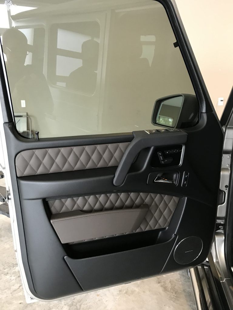 A close up of a car door with the door open.