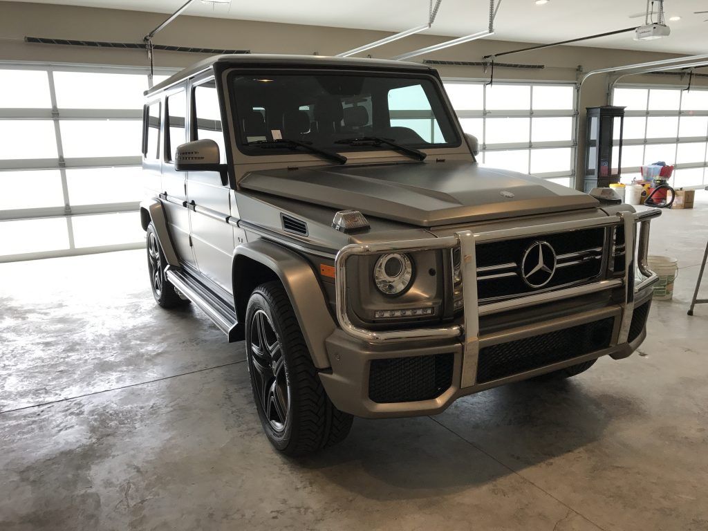 A mercedes benz g63 amg is parked in a garage.