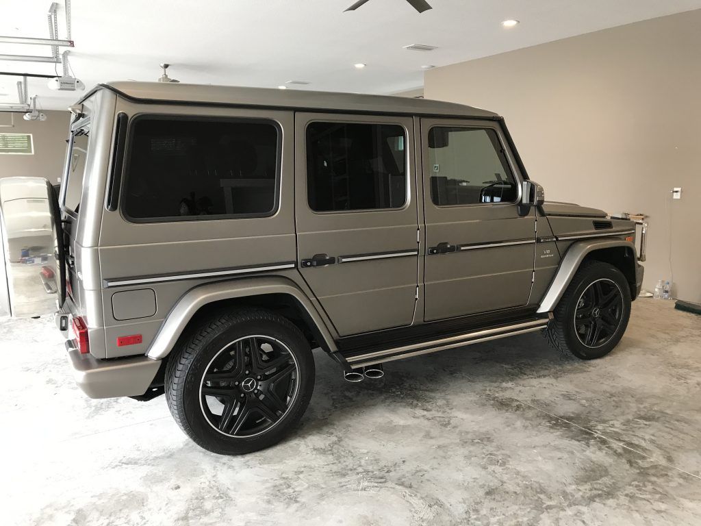A mercedes benz g63 amg is parked in a garage.