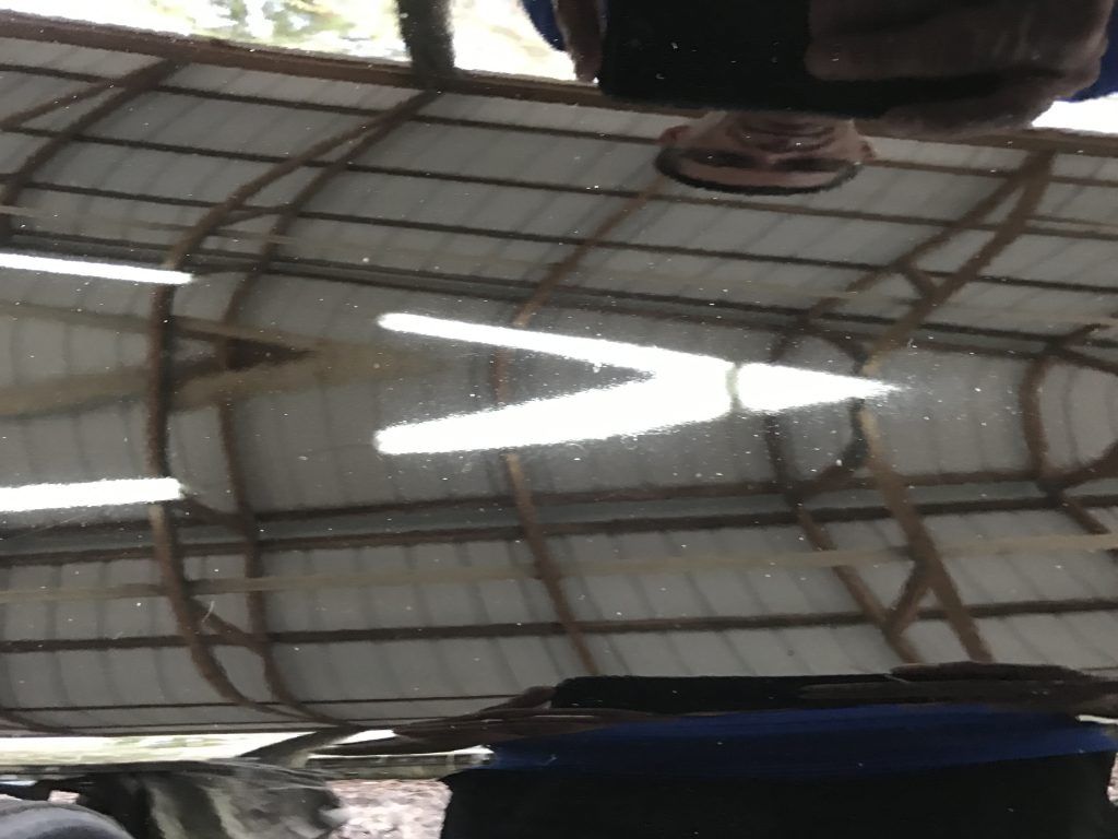 A reflection of a person in a mirror with an arrow pointing to the right