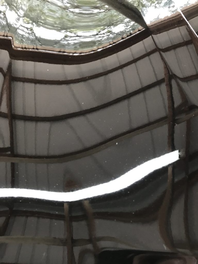 A ceiling with a reflection of a building in it