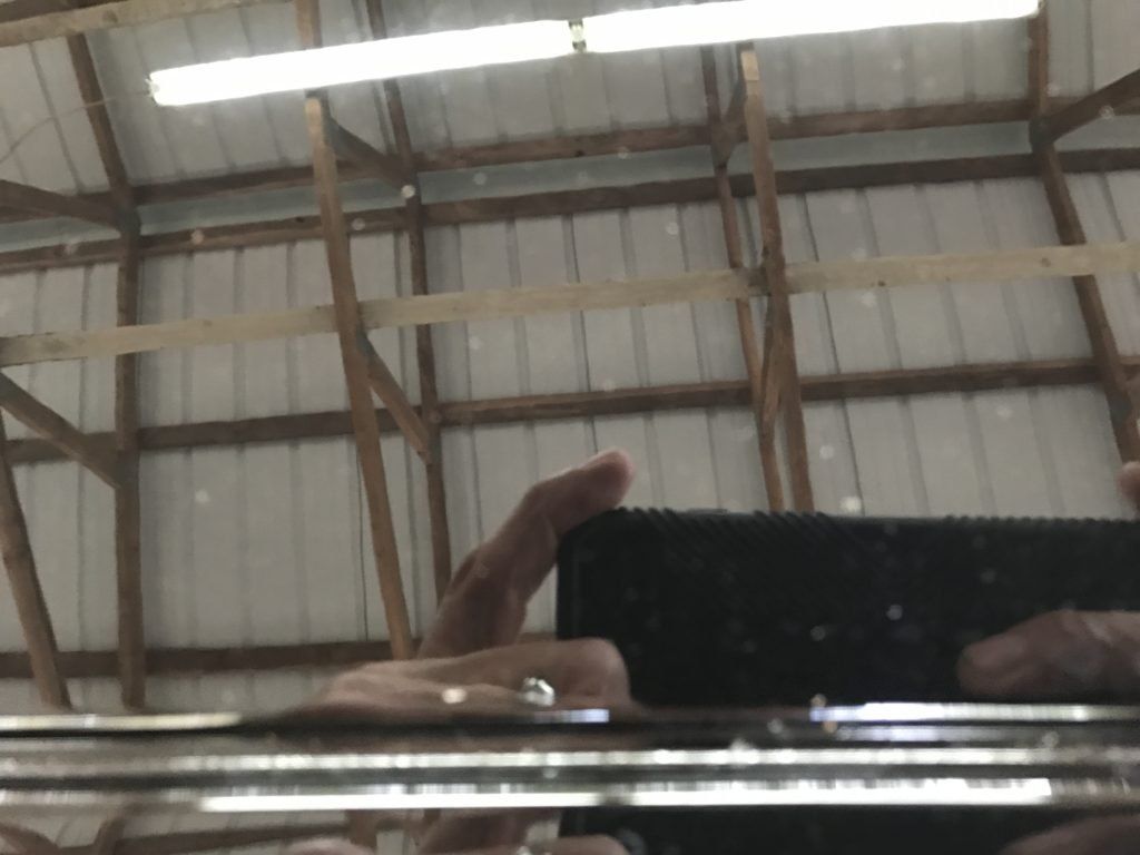 A person is taking a picture of their reflection in a mirror