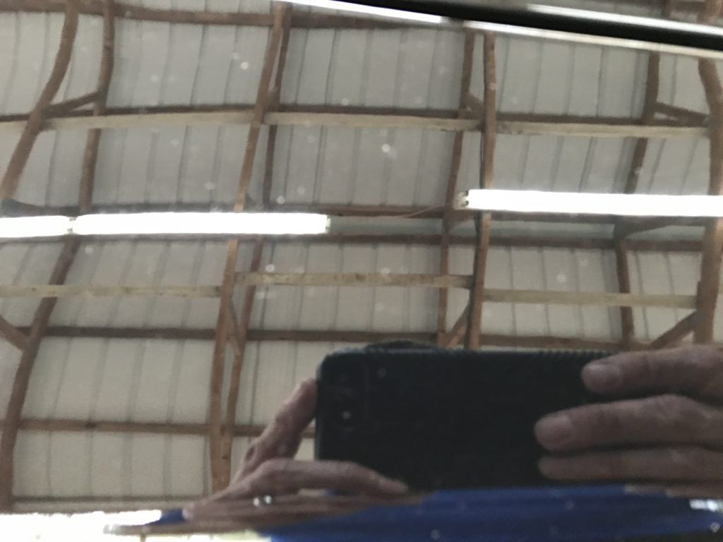 A person is taking a picture of their reflection in a mirror.