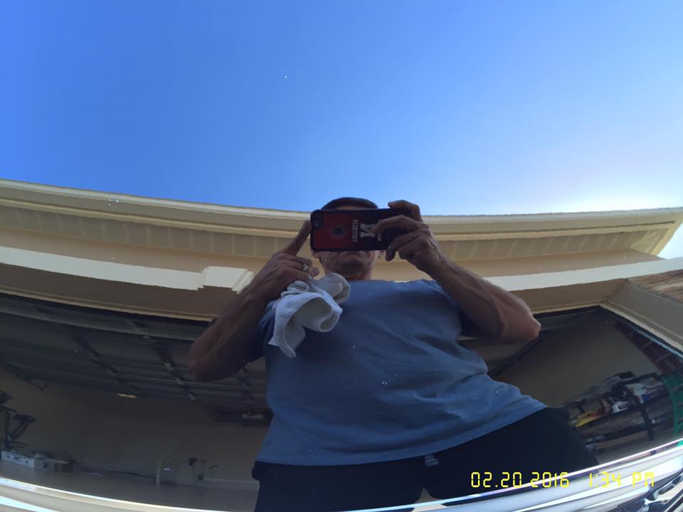 A man is taking a picture of himself in a garage.