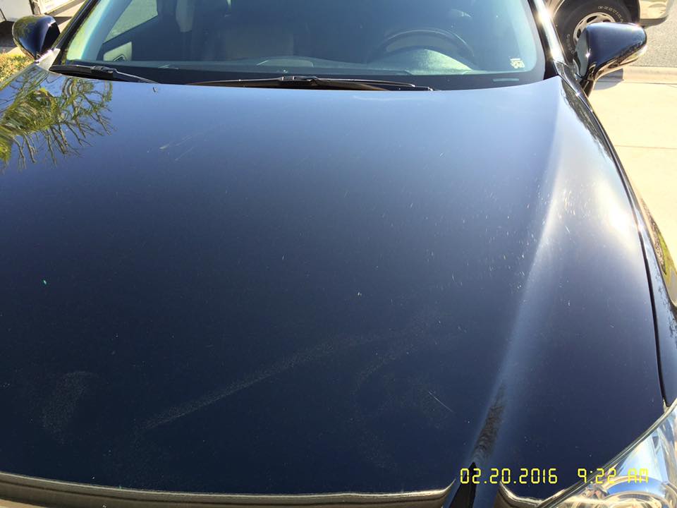 A close up of a car hood with the date 02 20 2016