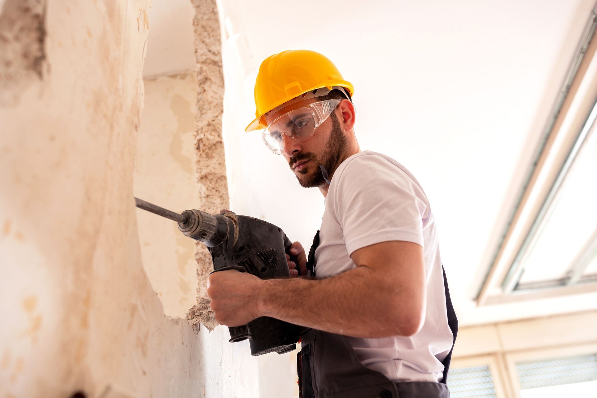 Concrete wall being chiseled, representing professional workmanship and concrete drilling methods.