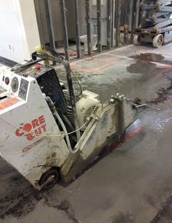 Concrete saw cutting a line in a concrete floor. 