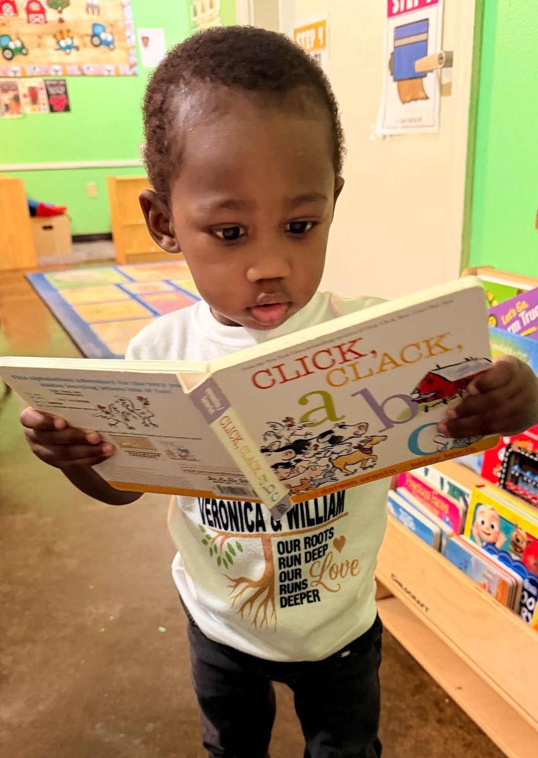 Two babies are sitting on the floor playing with toys.