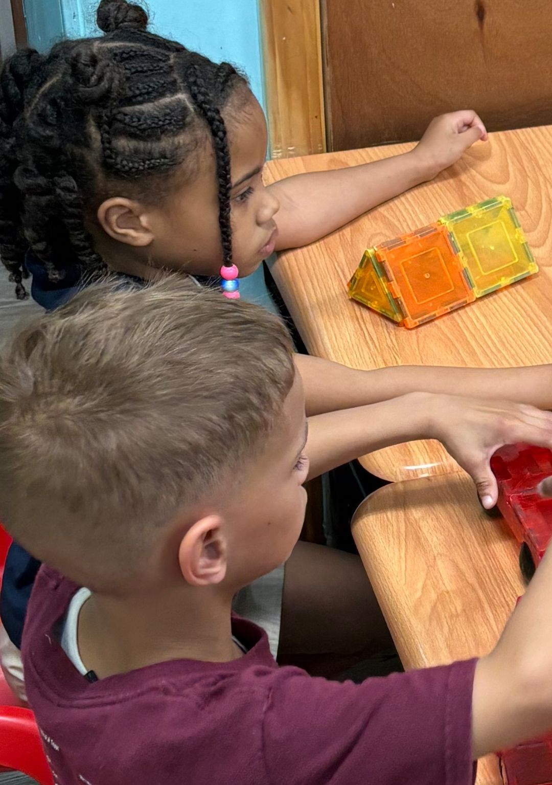 A young boy with glasses is hugging his father.